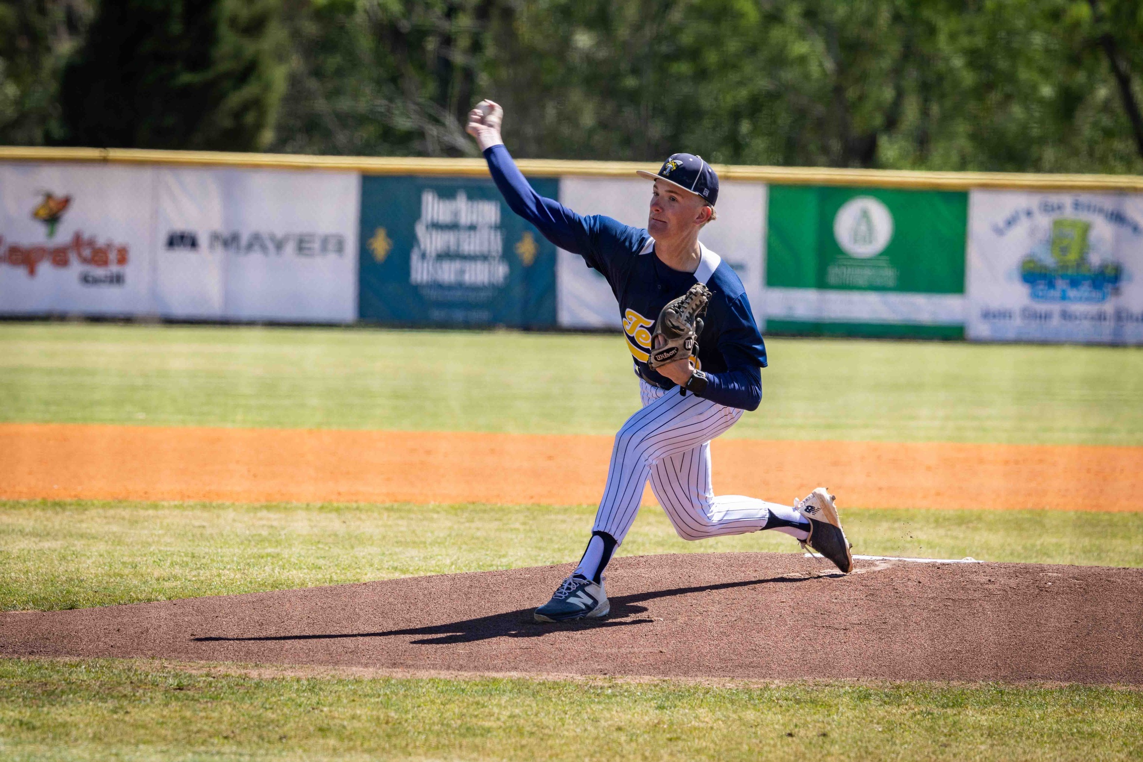 Jackson Mullen is seen on the pitcher's mound throwing the baseball.